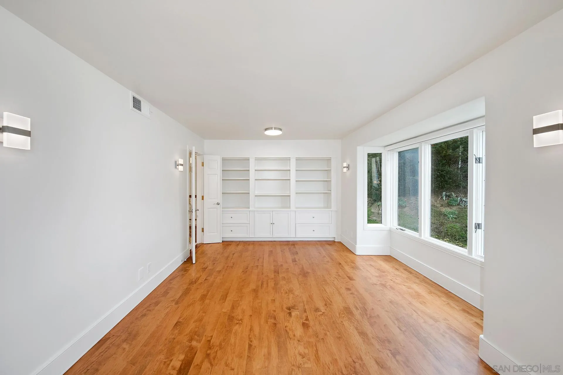 1735 Seaview Avenue Del Mar, CA 92014 - Photo 9 of 51 a view of an empty room with a window and wooden floor