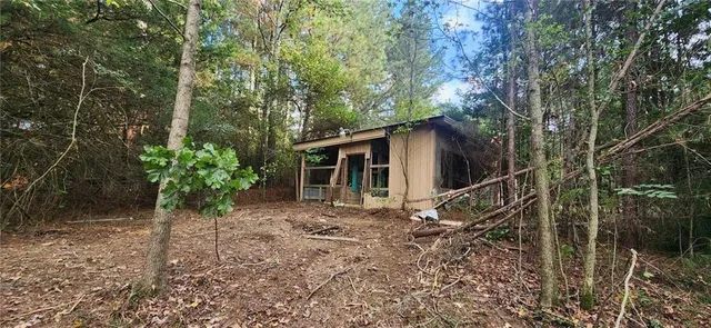 a view of a house with a yard and potted plants