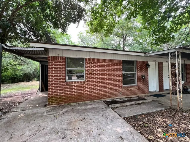 a view of a backyard with a large tree