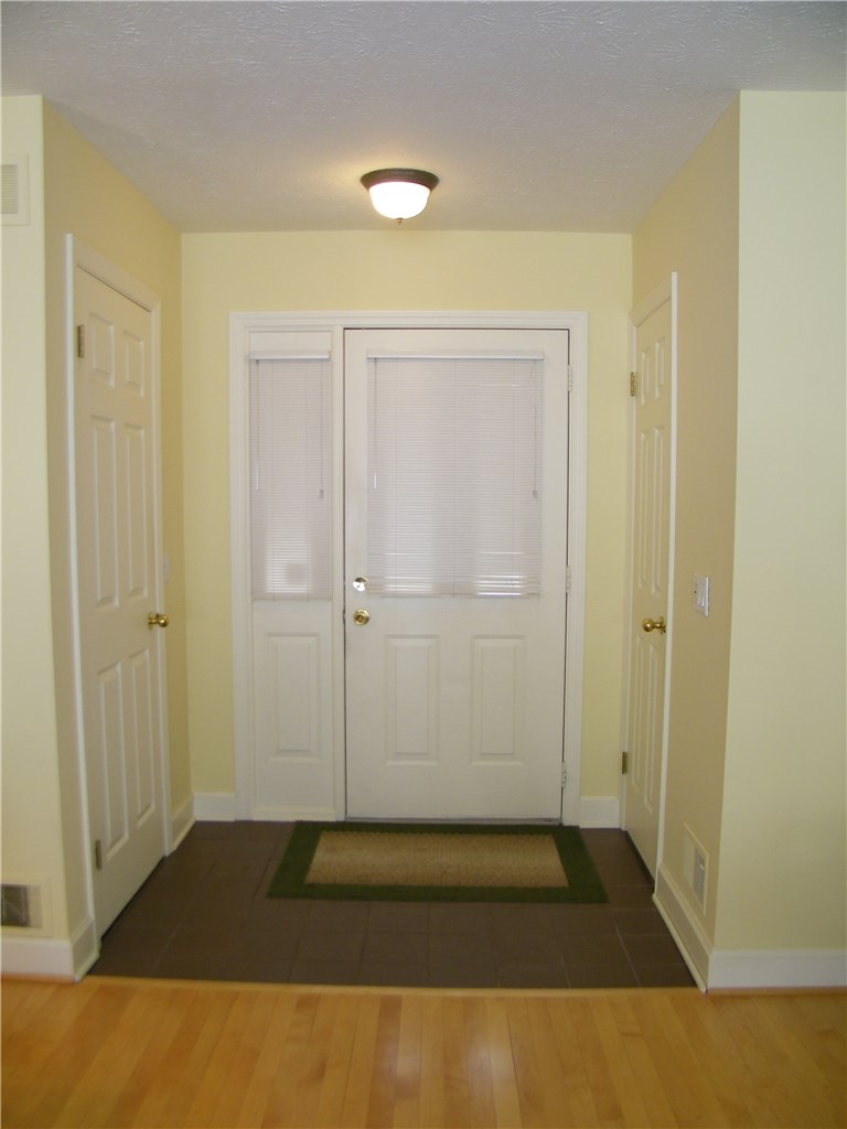 221 Highland Parkway Rochester, NY 14620 - Photo 1 of 1 The front entry flanked by a large closet and a po
