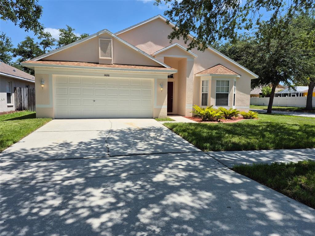 11626 Pure Pebble Drive Riverview, FL 33569 - Photo 1 of 1 a front view of a house with a yard and garage