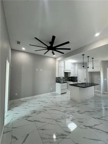 a large kitchen with kitchen island a sink stainless steel appliances and cabinets