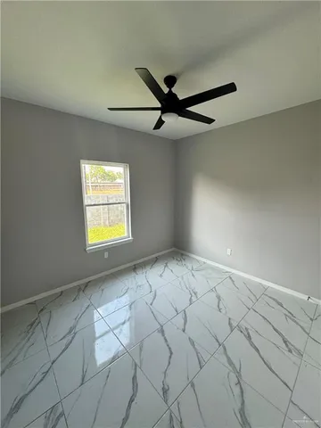 a view of an empty room and a window