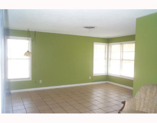 128 Marie Place Portland, TX 78374 - Photo 2 of 4 a view of an empty room with wooden floor and a window