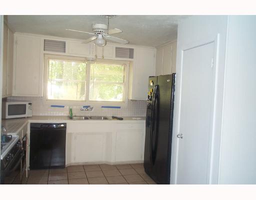 128 Marie Place Portland, TX 78374 - Photo 3 of 4 a kitchen with a refrigerator and a sink