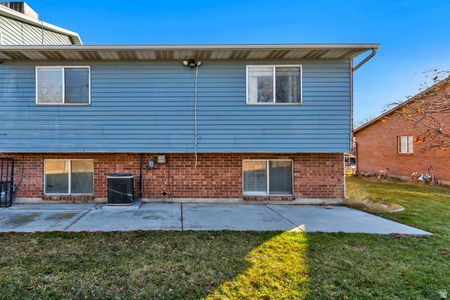 933 South Freedom Boulevard, Unit 7 Provo, UT 84601 - Photo 22 of 23 Back of property featuring a patio and a yard