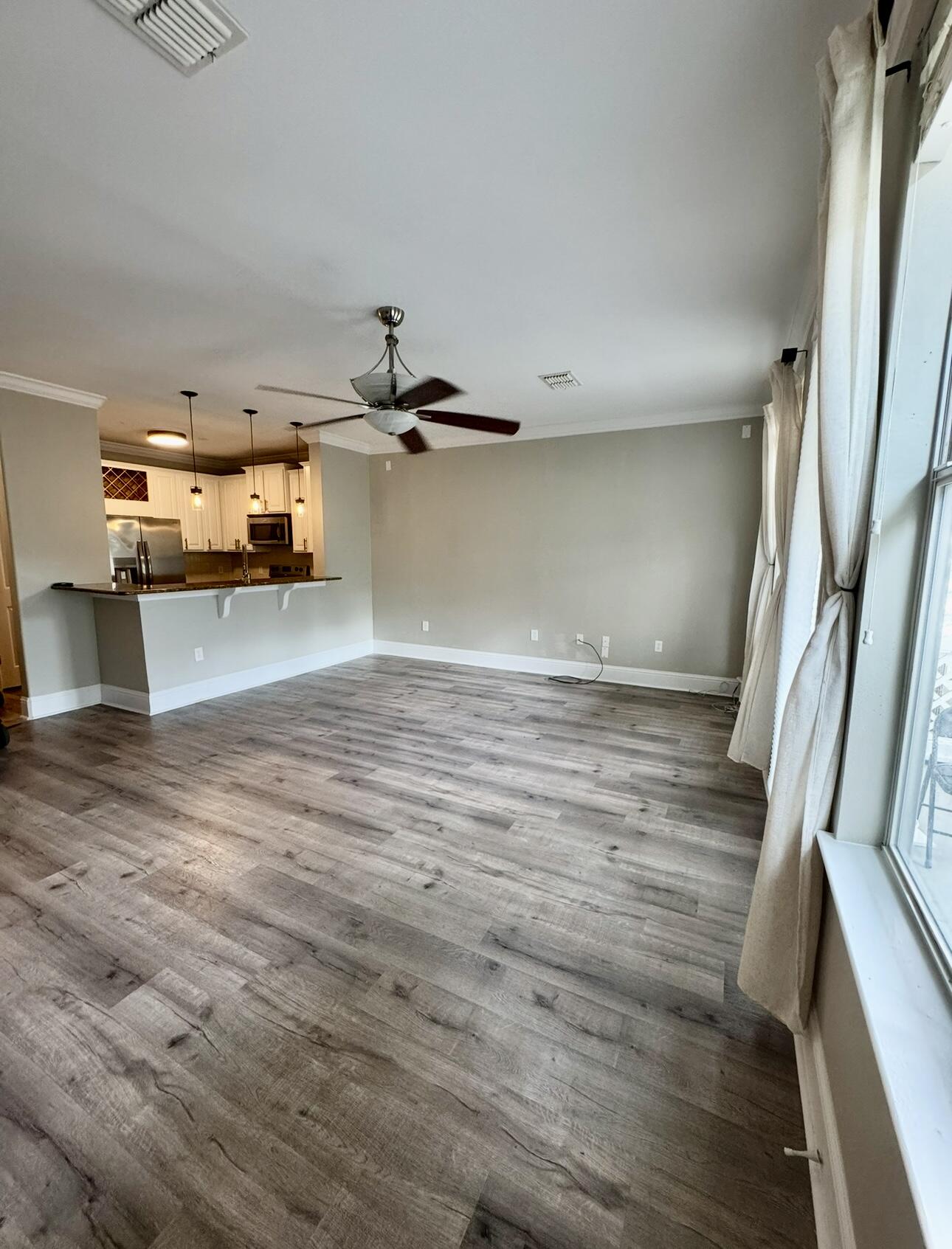 a view of a kitchen with a sink and cabinets