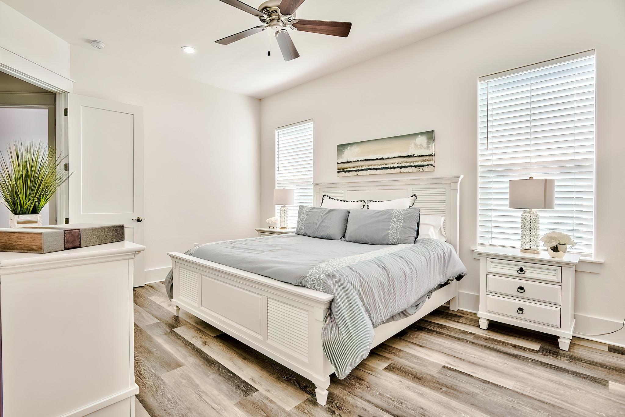 61 Carefree Lane Santa Rosa Beach, FL 32459 - Photo 15 of 30 a bedroom with a bed and a chandelier