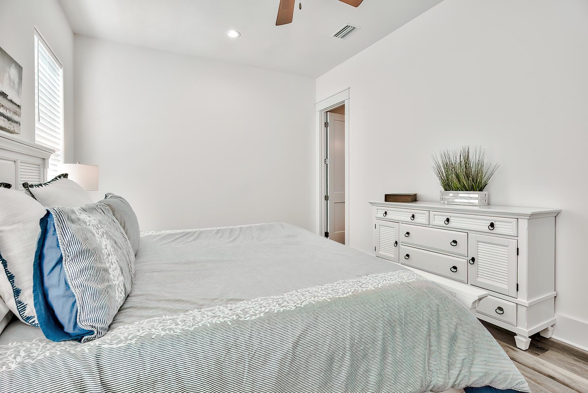 61 Carefree Lane Santa Rosa Beach, FL 32459 - Photo 16 of 30 a bedroom with a bed and a flat tv screen on dresser