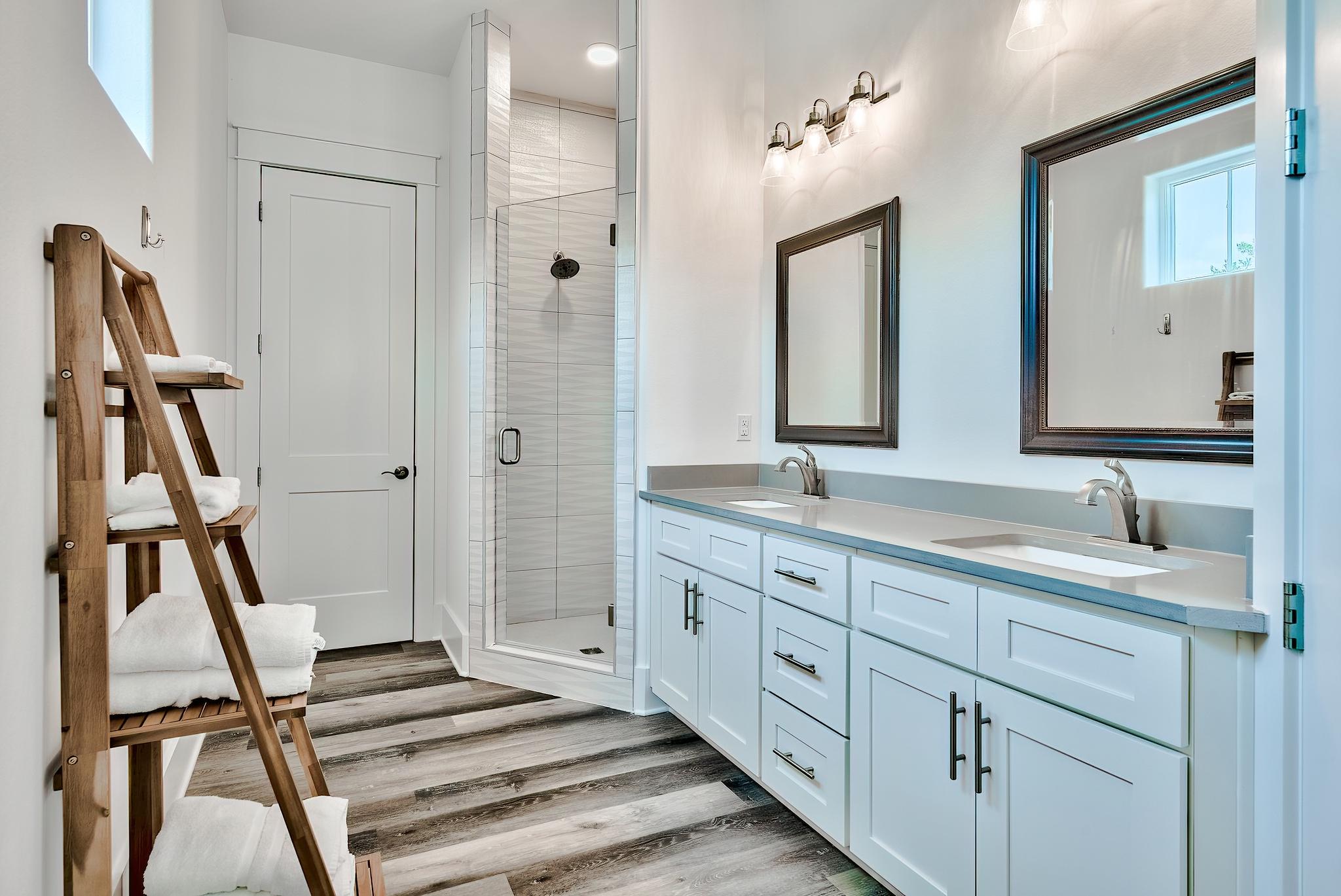 61 Carefree Lane Santa Rosa Beach, FL 32459 - Photo 18 of 30 a bathroom with a double vanity sink and a mirror
