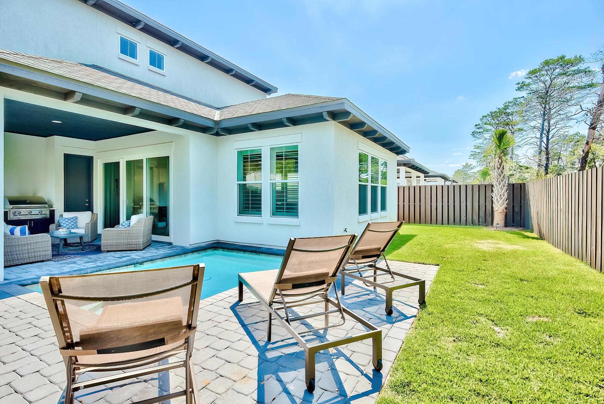 61 Carefree Lane Santa Rosa Beach, FL 32459 - Photo 28 of 30 a view of a house with backyard and porch