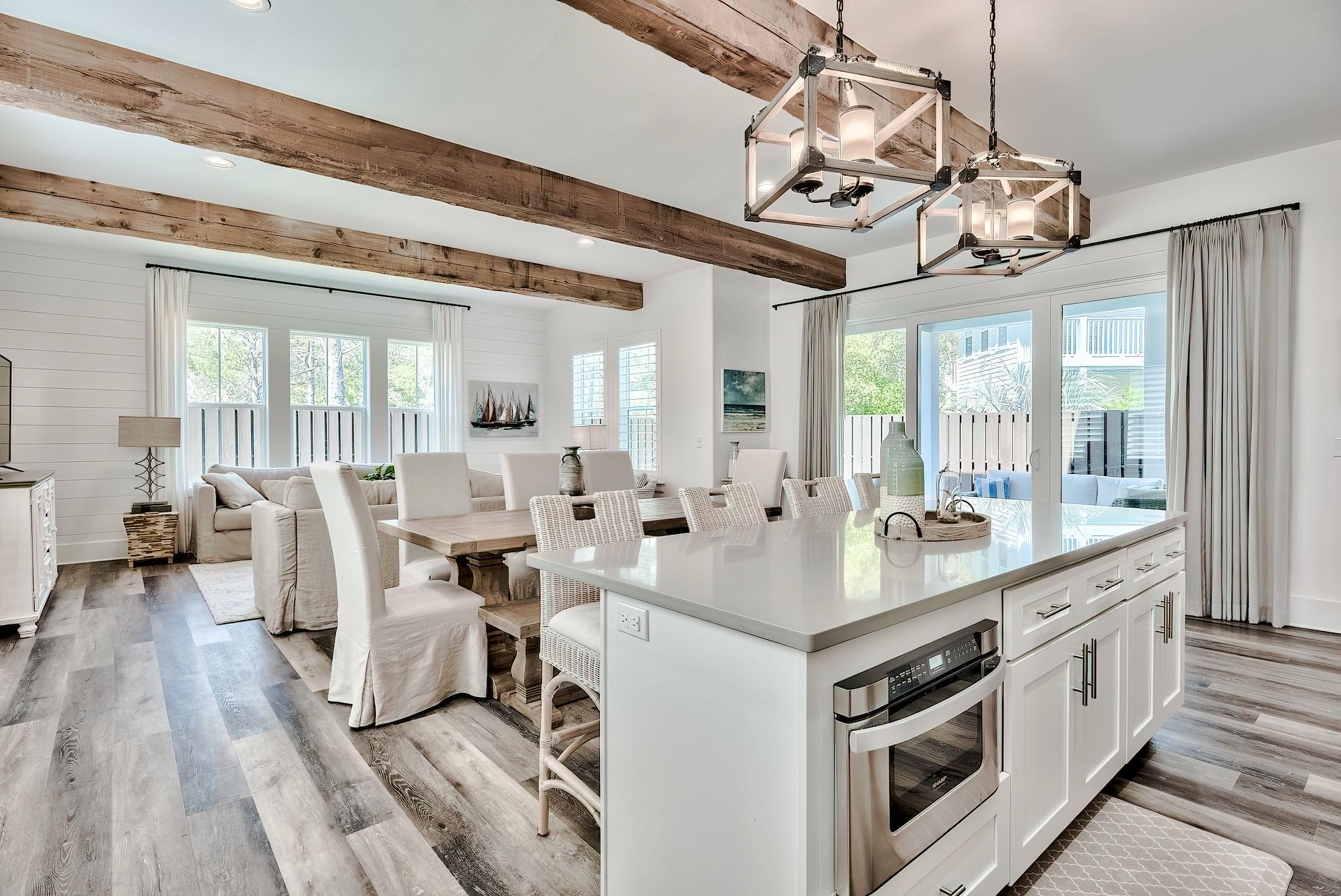 61 Carefree Lane Santa Rosa Beach, FL 32459 - Photo 3 of 30 a open kitchen with stainless steel appliances granite countertop a stove and couches with wooden floor