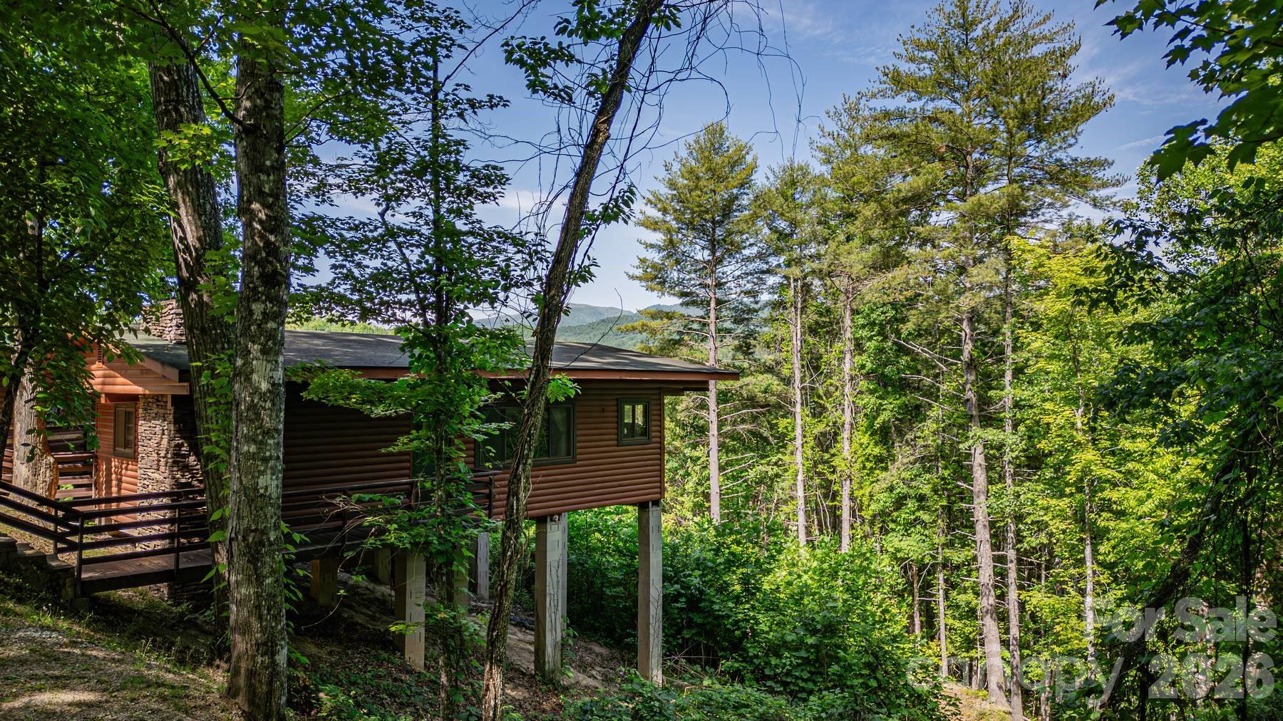 319 Blue Ridge Parkway, Unit 53 Bryson City, NC 28713 - Photo 16 of 22 a front view of a house with plants and trees