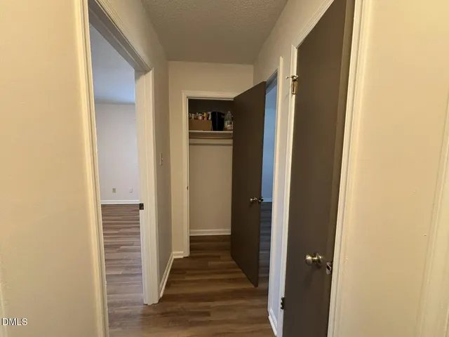 a view of a hallway with wooden floor