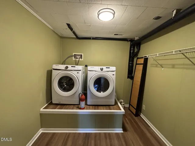 a view of a room with wooden floor