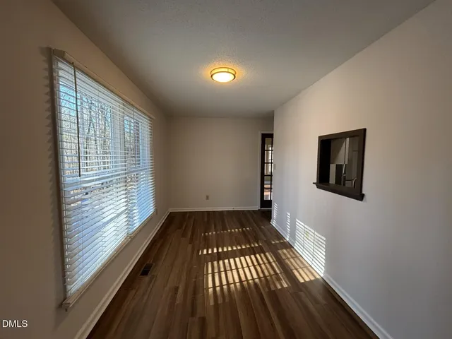 a view of hallway with wooden floor