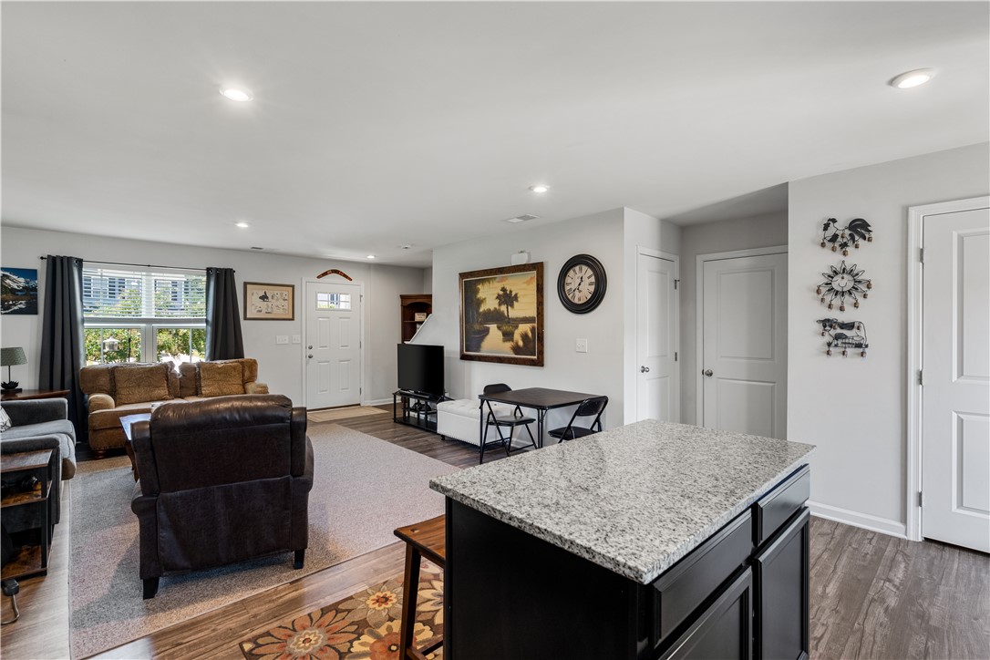 115 Queens Mill Court Pendleton, SC 29670 - Photo 32 of 32 An open floorplan seamlessly connects the stone island kitchen to a comfortable living area.
