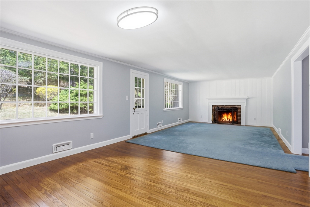 11 Sherman's Bridge Road Wayland, MA 01778 - Photo 13 of 38 a view of empty room with wooden floor and fan