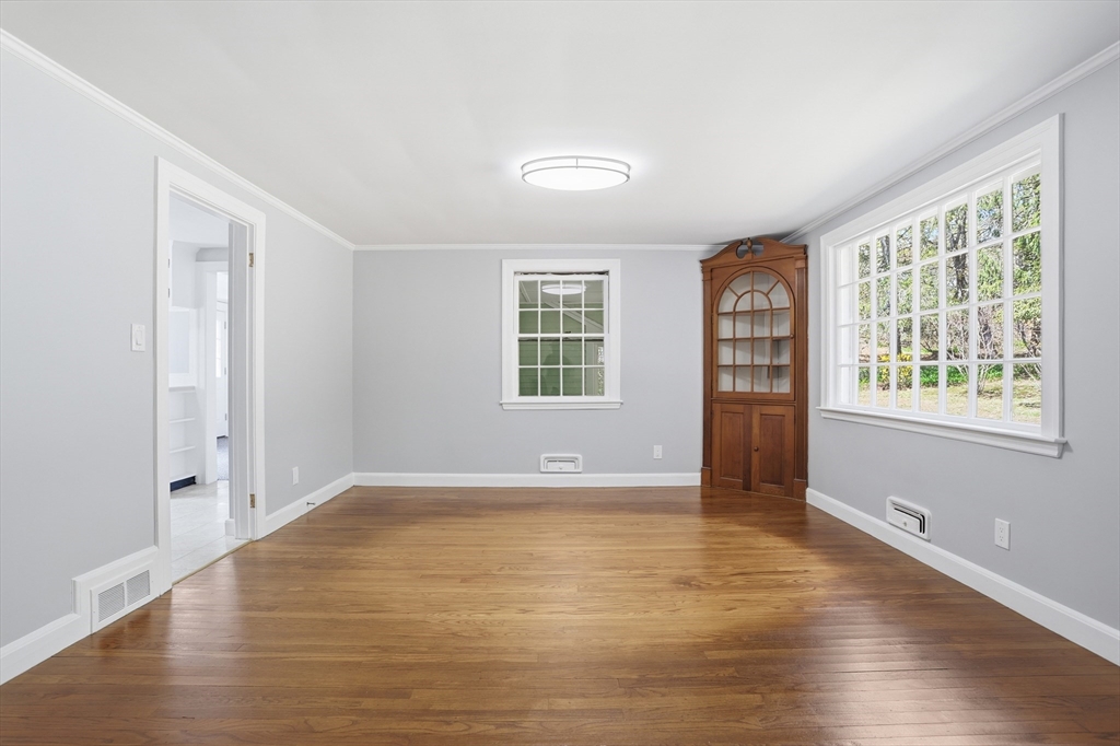 11 Sherman's Bridge Road Wayland, MA 01778 - Photo 18 of 38 an empty room with wooden floor and windows