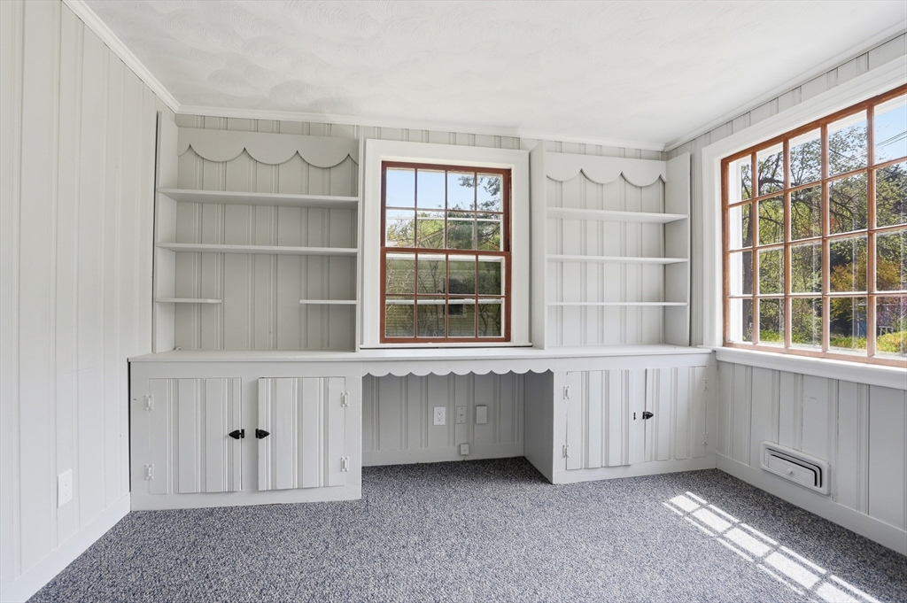 11 Sherman's Bridge Road Wayland, MA 01778 - Photo 20 of 38 a living room with a window and cabinet