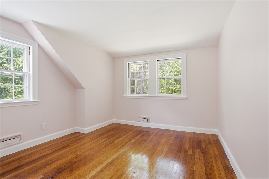 11 Sherman's Bridge Road Wayland, MA 01778 - Photo 24 of 38 an empty room with wooden floor and windows