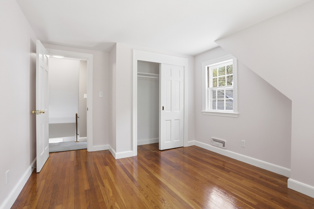 11 Sherman's Bridge Road Wayland, MA 01778 - Photo 25 of 38 a view of a room with wooden floor and a window