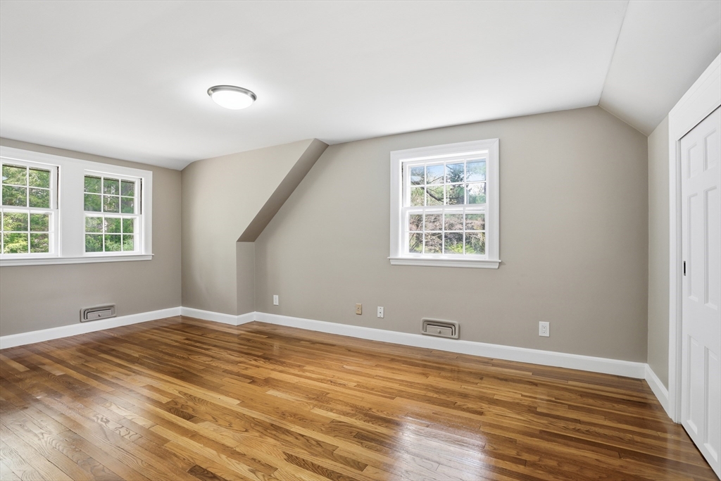 11 Sherman's Bridge Road Wayland, MA 01778 - Photo 28 of 38 a view of an empty room with wooden floor and a window