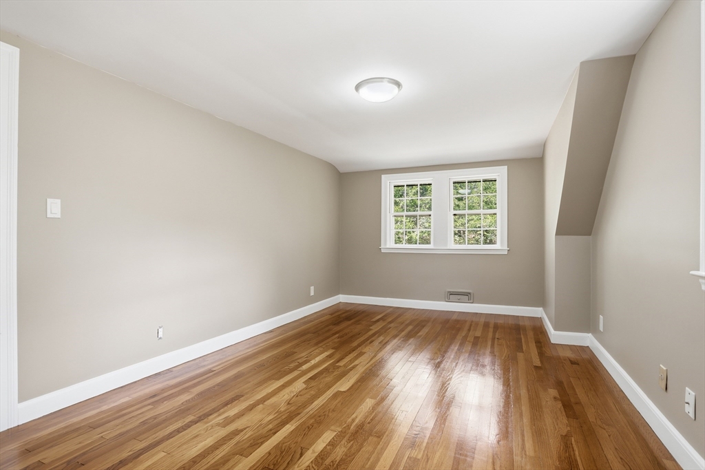 11 Sherman's Bridge Road Wayland, MA 01778 - Photo 29 of 38 an empty room with wooden floor and windows