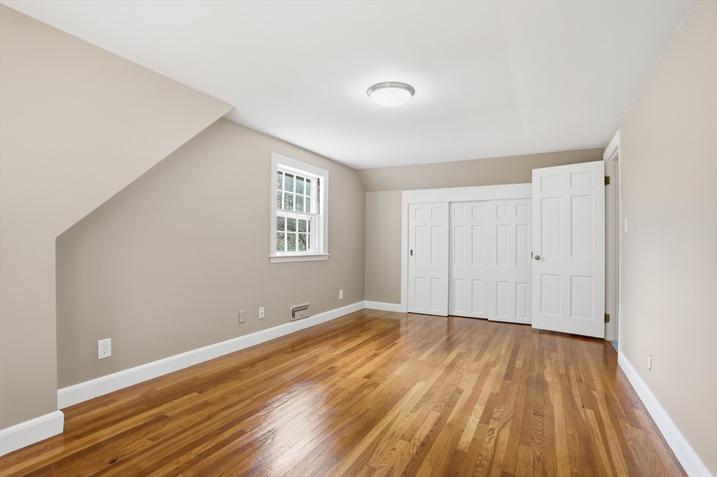 11 Sherman's Bridge Road Wayland, MA 01778 - Photo 30 of 38 a view of a room with wooden floor and white walls