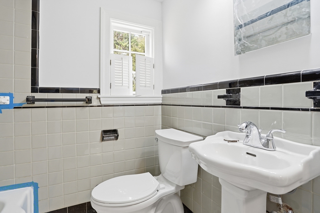 11 Sherman's Bridge Road Wayland, MA 01778 - Photo 32 of 38 a bathroom with a sink a toilet and mirror