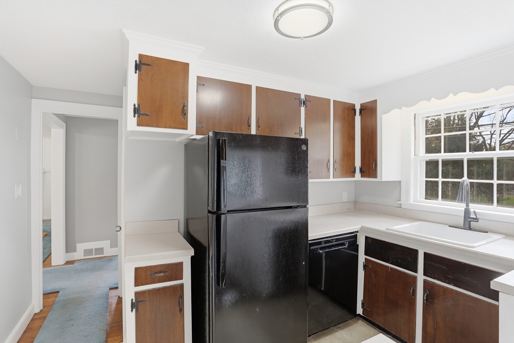 11 Sherman's Bridge Road Wayland, MA 01778 - Photo 10 of 38 a kitchen with stainless steel appliances a refrigerator sink and cabinets