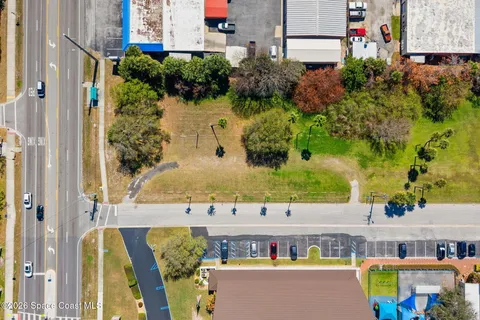 an aerial view of residential houses with outdoor space and swimming pool