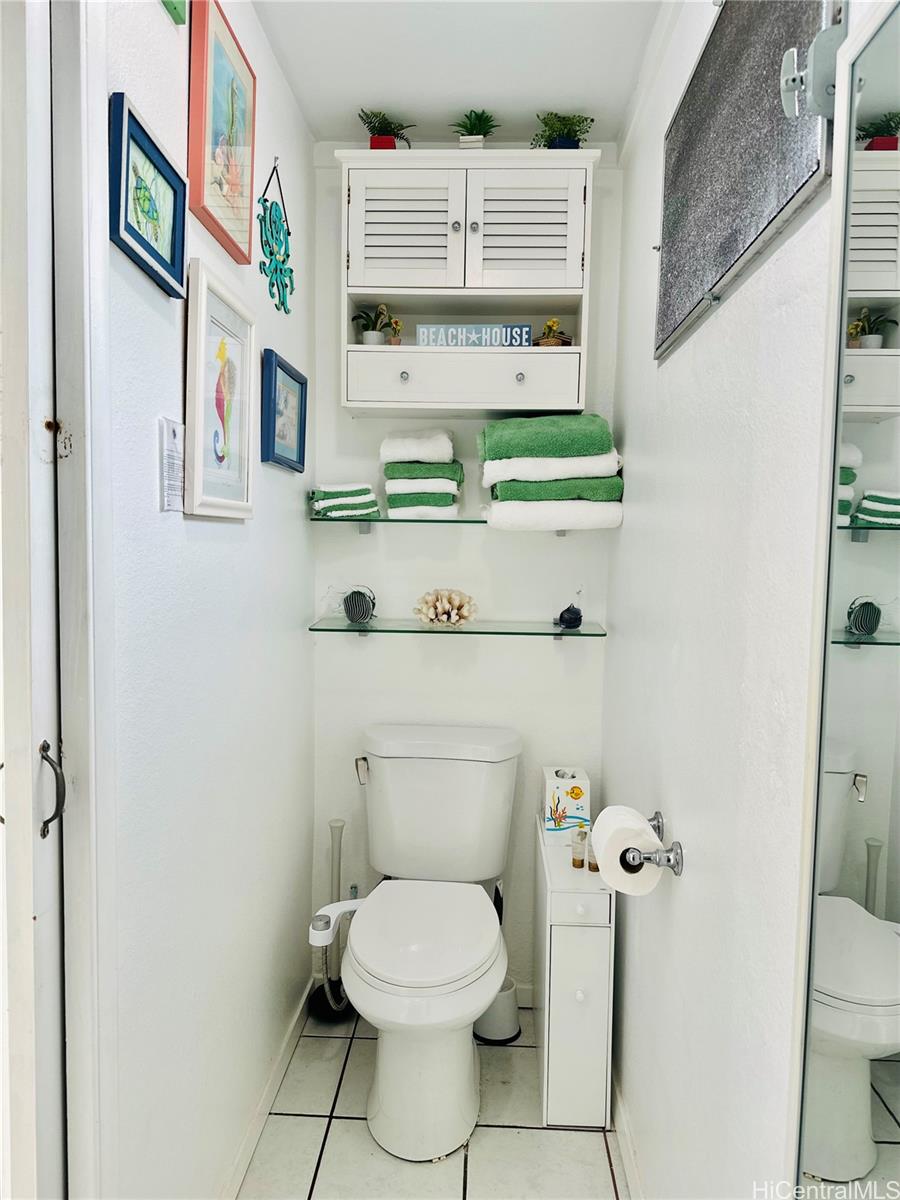 Undisclosed Address Waimanalo, HI 96795 - Photo 8 of 10 a bathroom with a toilet sink and mirror