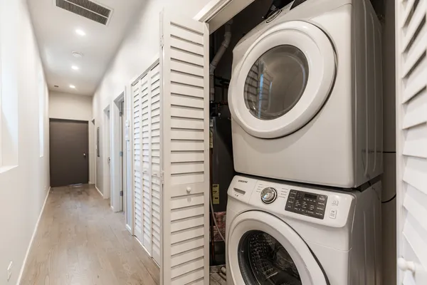 a view of a hallway with washer and dryer