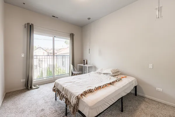 a bedroom with a bed and a large window