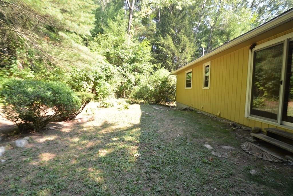 442 Warren Wright Road Belchertown, MA 01007 - Photo 35 of 35 a backyard of a house with yard and tree