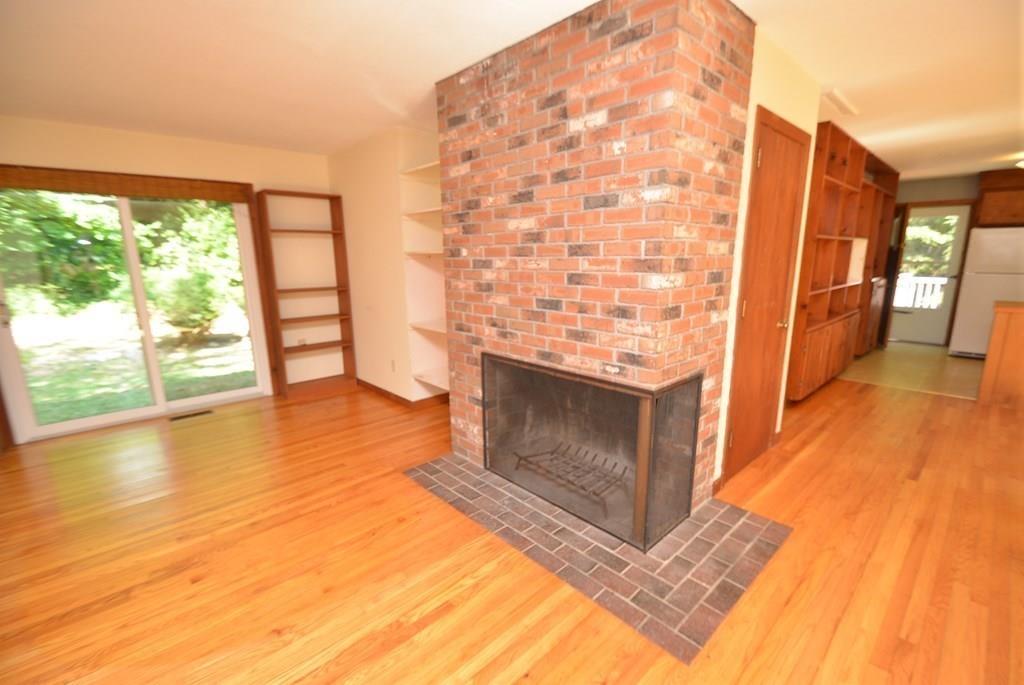 442 Warren Wright Road Belchertown, MA 01007 - Photo 8 of 35 a view of empty room with wooden floor and fireplace