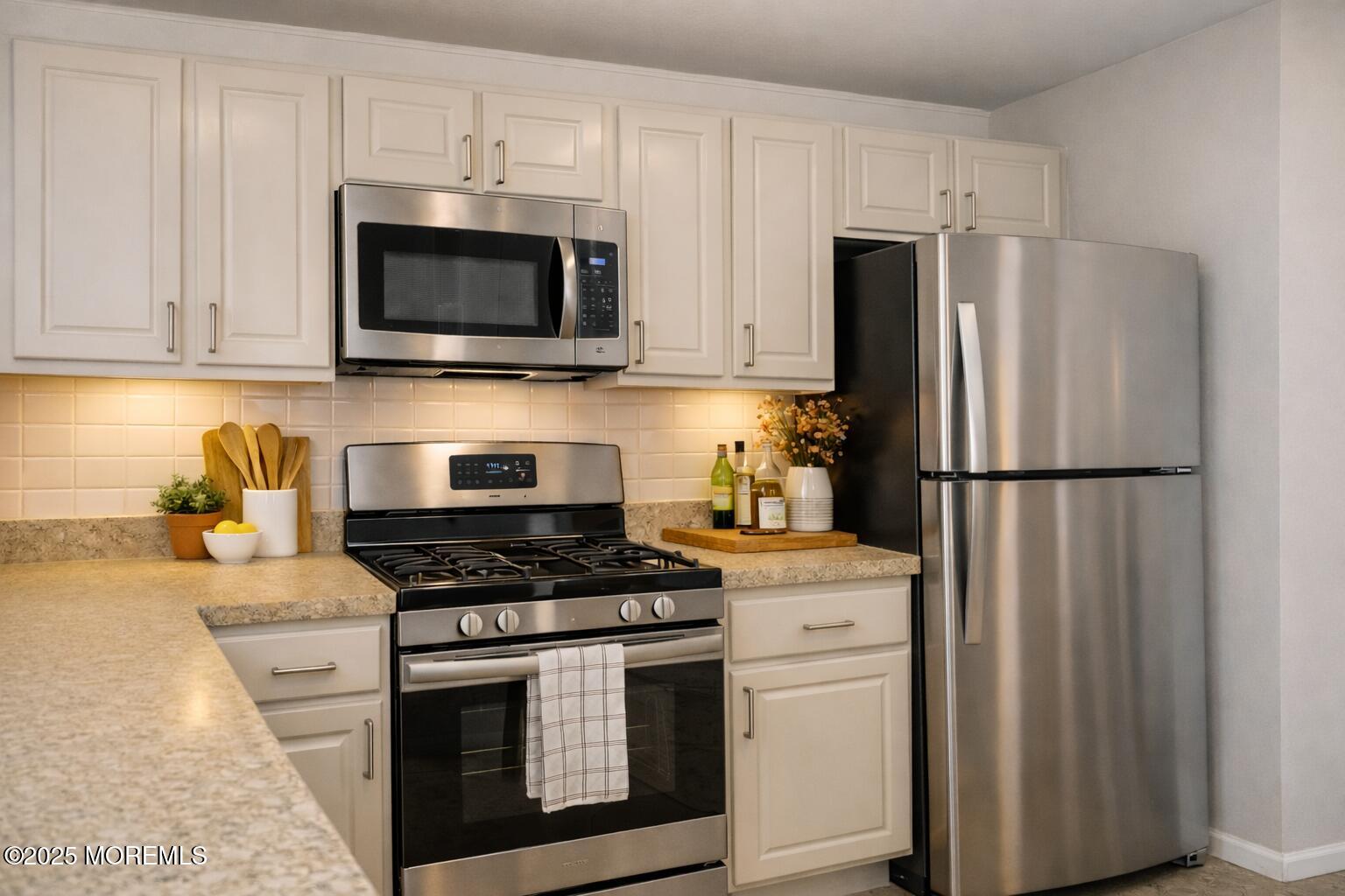 705 Bluebell Drive Jackson, NJ 08527 - Photo 16 of 44 a kitchen with cabinets stainless steel appliances and a counter space