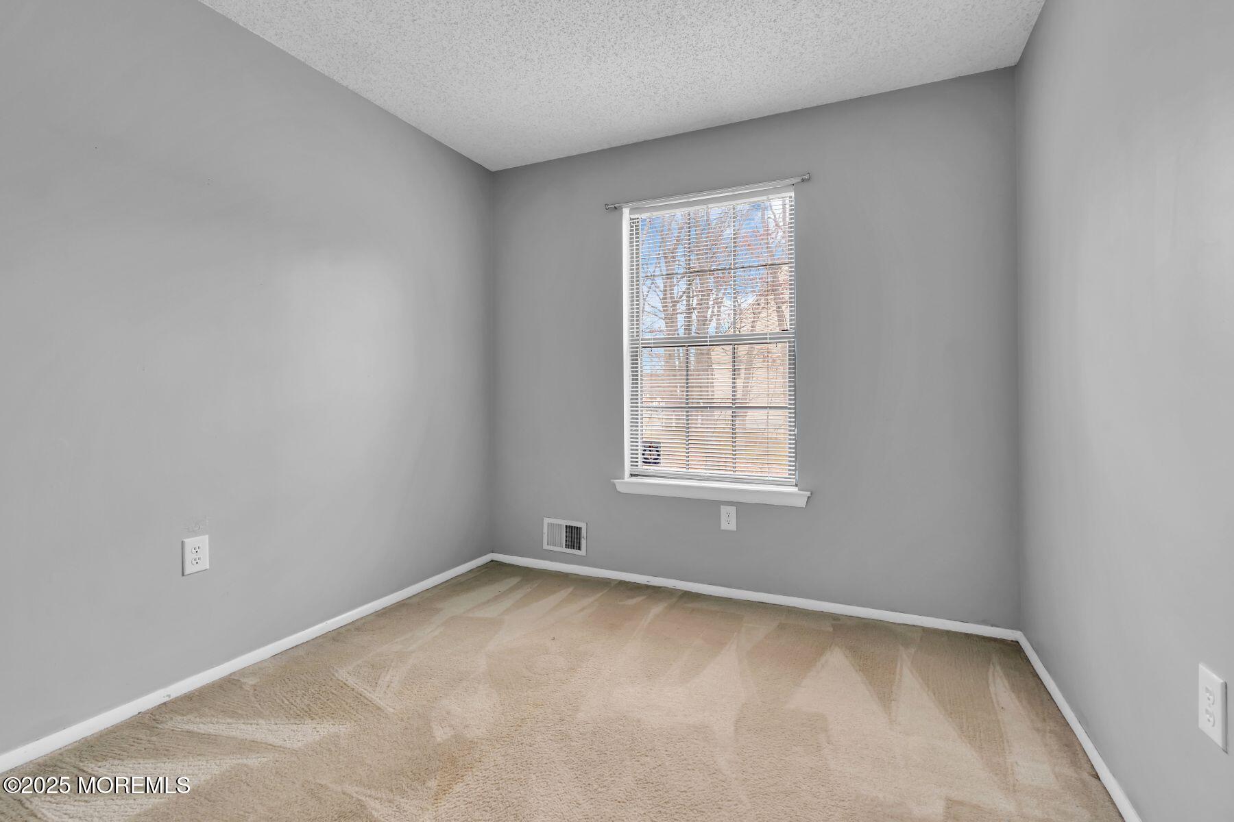705 Bluebell Drive Jackson, NJ 08527 - Photo 19 of 44 an empty room with a window