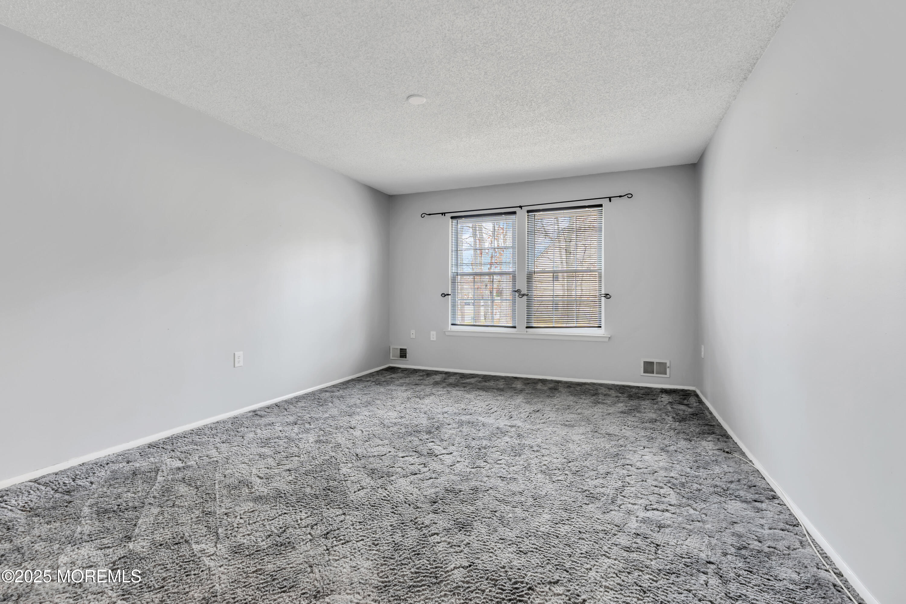 705 Bluebell Drive Jackson, NJ 08527 - Photo 21 of 44 an empty room with windows