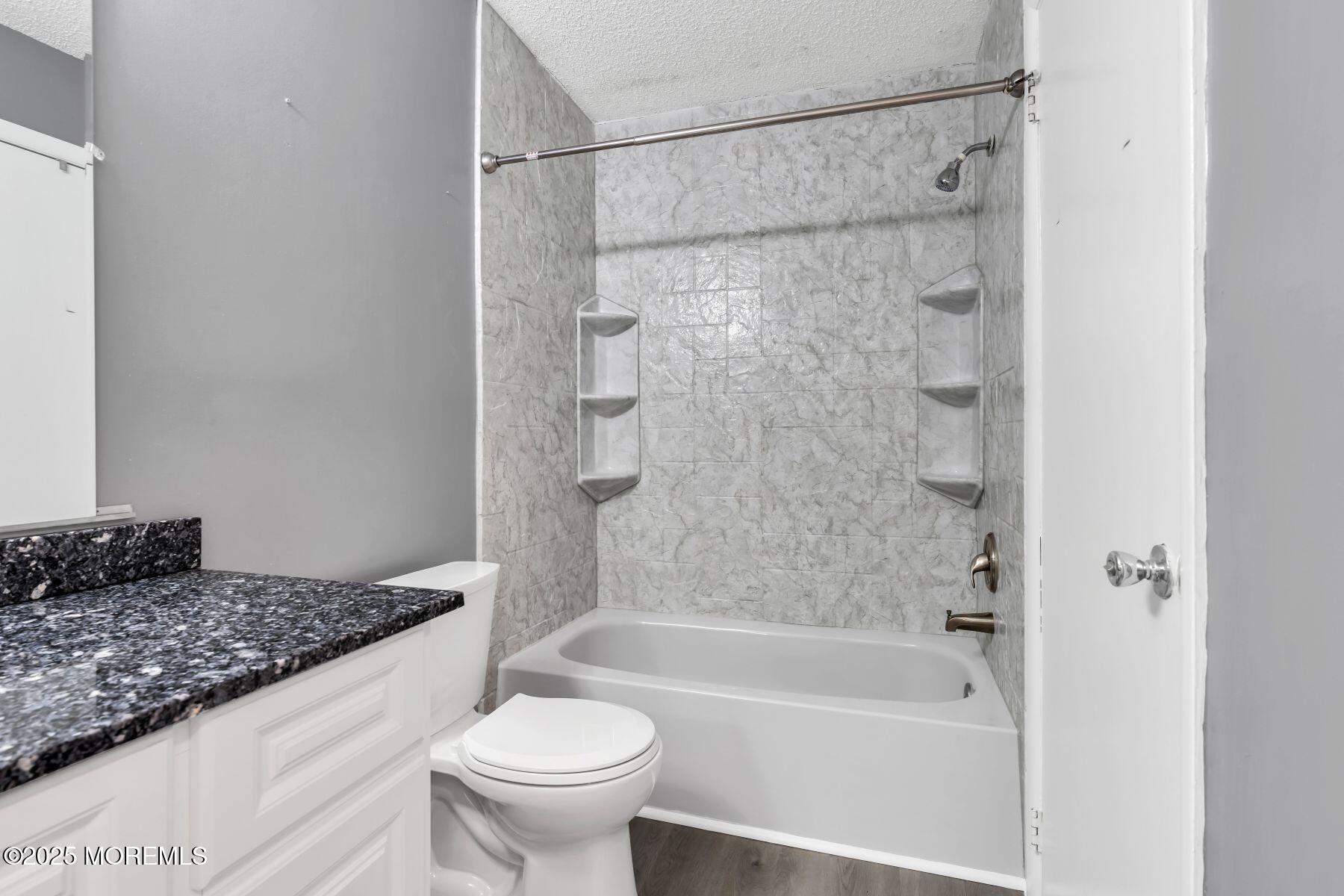 705 Bluebell Drive Jackson, NJ 08527 - Photo 27 of 44 a bathroom with a granite countertop bathtub shower sink vanity and toilet