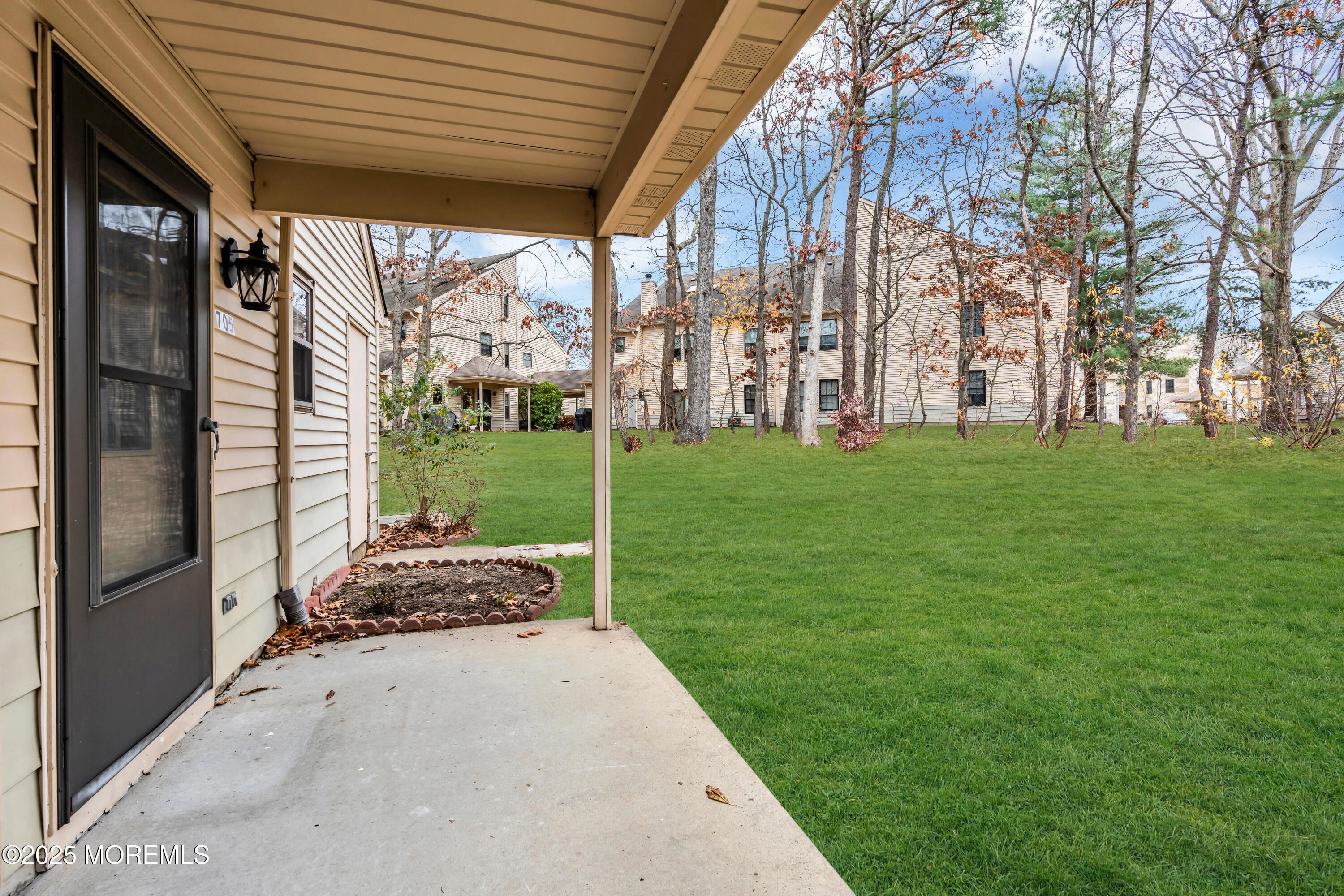705 Bluebell Drive Jackson, NJ 08527 - Photo 4 of 44 a backyard of a house with a garden and outdoor seating