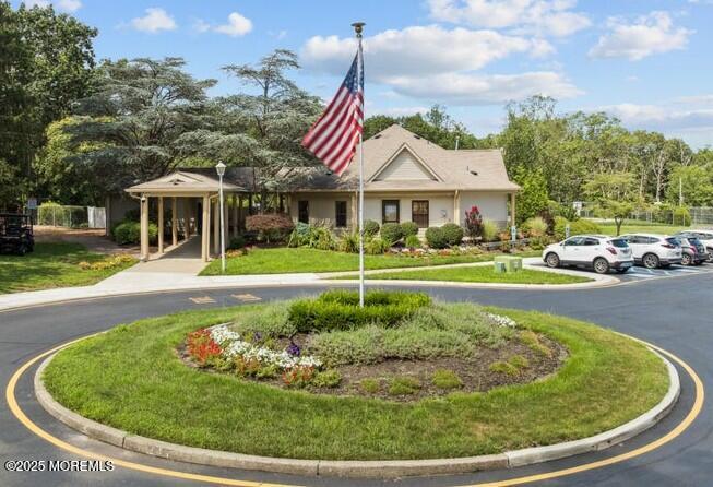 705 Bluebell Drive Jackson, NJ 08527 - Photo 43 of 44 a view of a white house with a swimming pool and lawn chairs