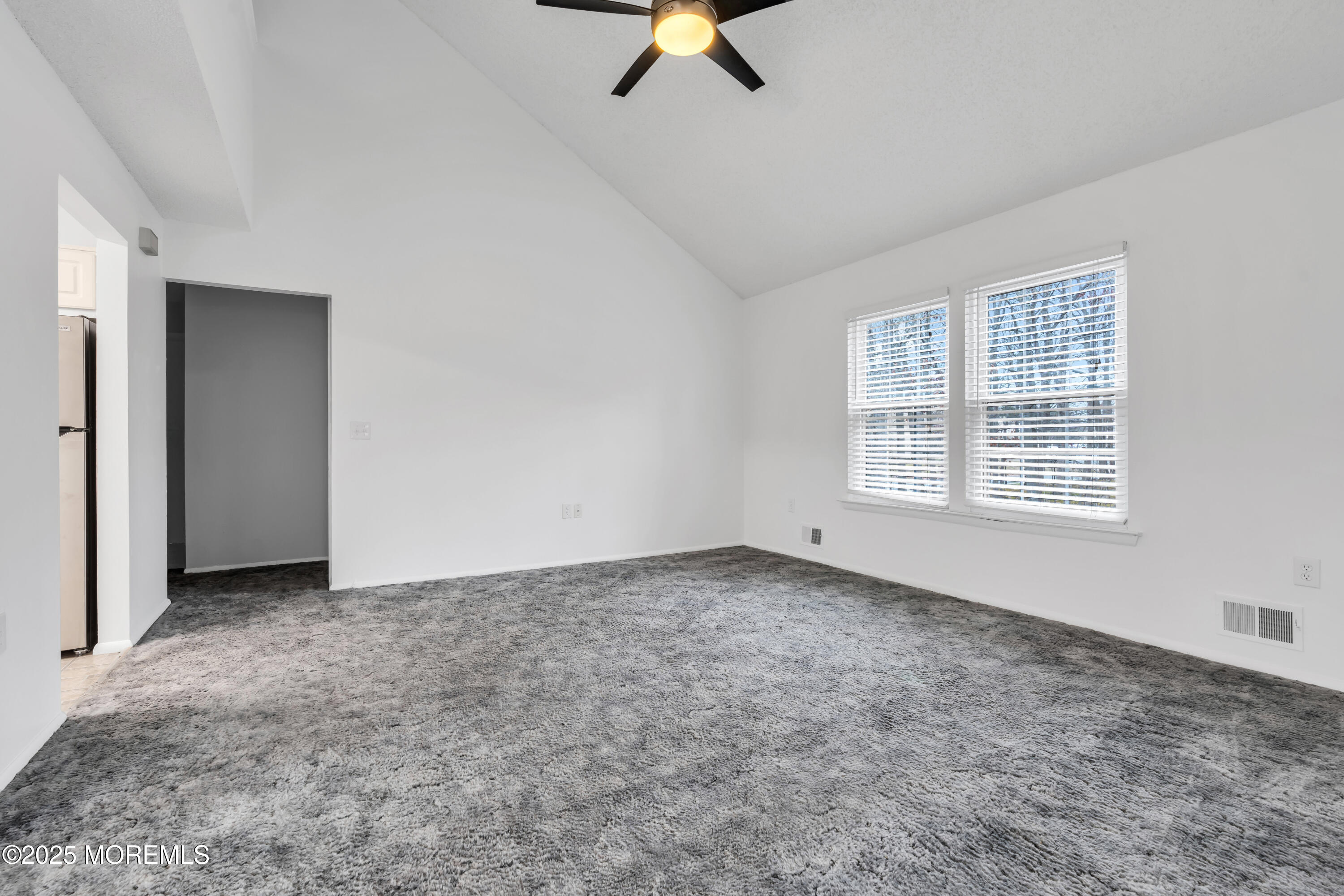 705 Bluebell Drive Jackson, NJ 08527 - Photo 10 of 44 an empty room with fan and windows
