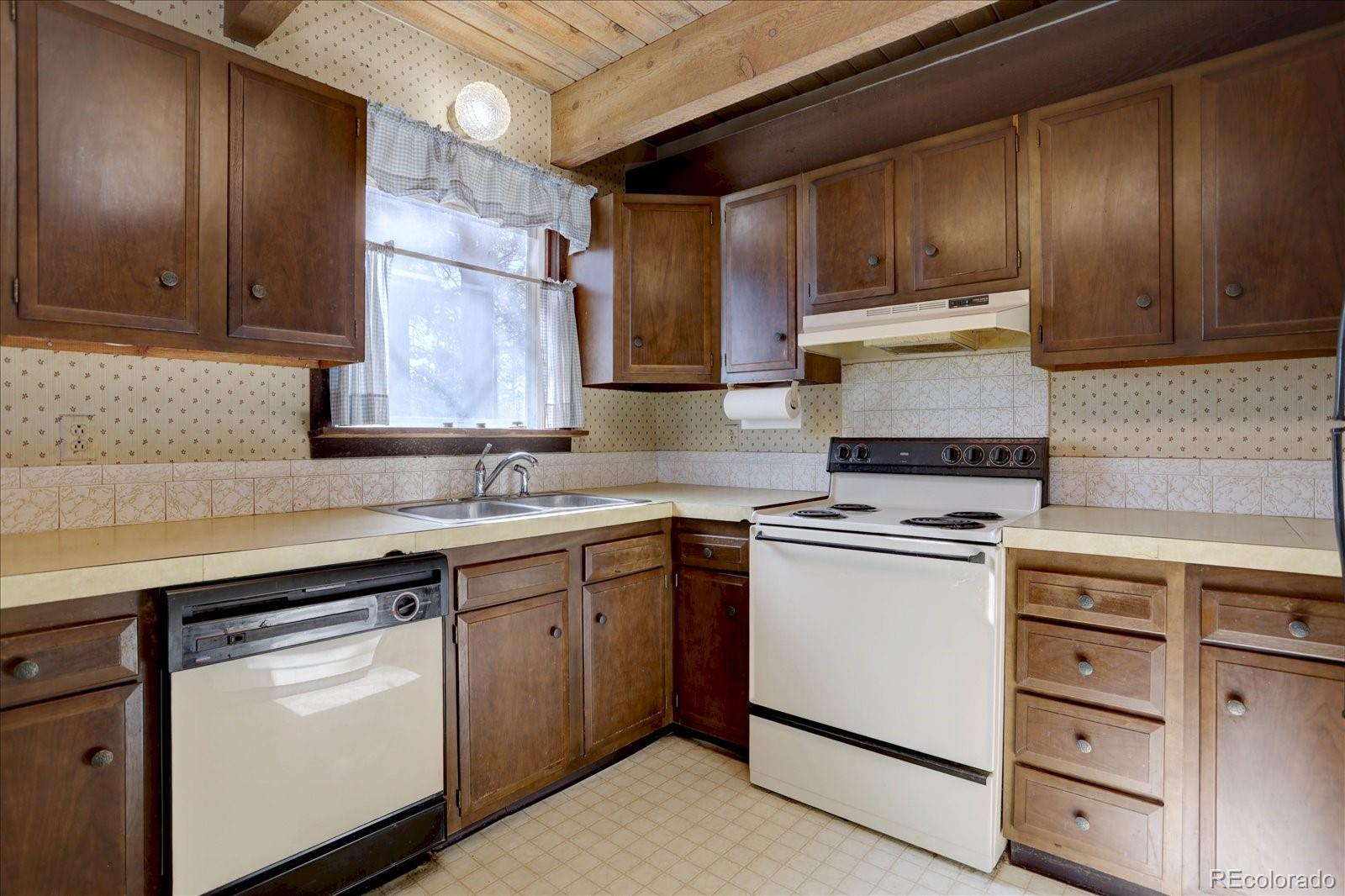 1999 Roland Drive Bailey, CO 80421 - Photo 16 of 33 a kitchen with cabinets appliances a sink and a counter top space