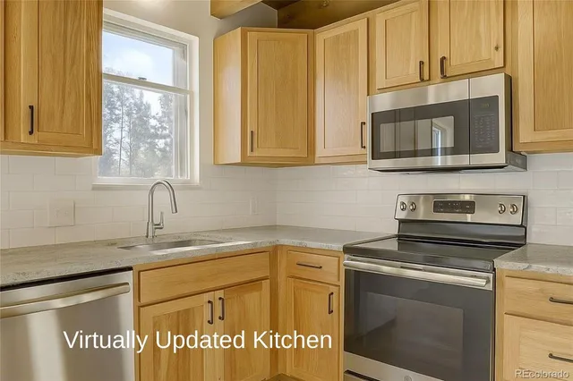 a kitchen with stainless steel appliances granite countertop a sink stove and microwave