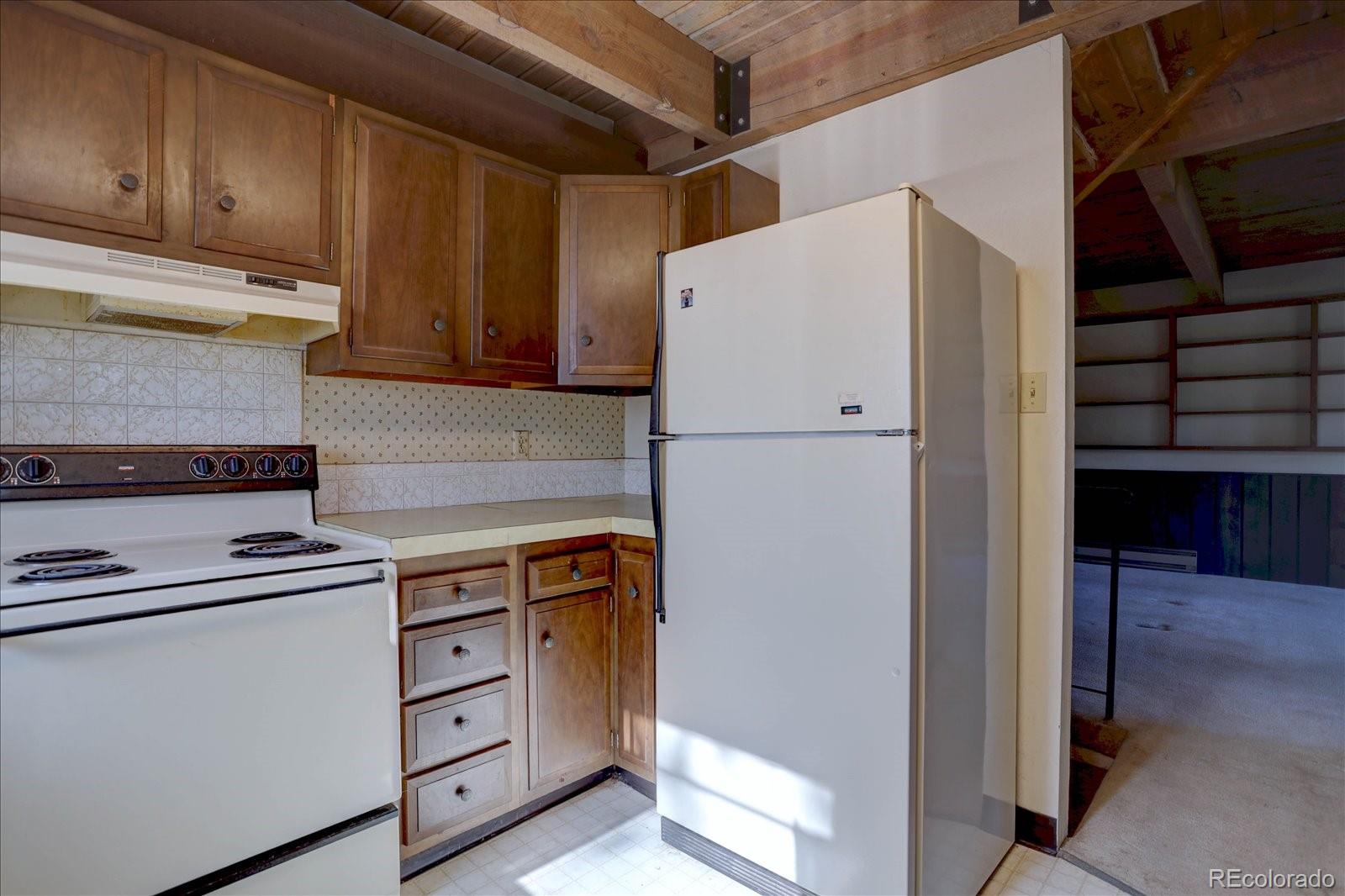 1999 Roland Drive Bailey, CO 80421 - Photo 18 of 33 a kitchen with a refrigerator and a stove