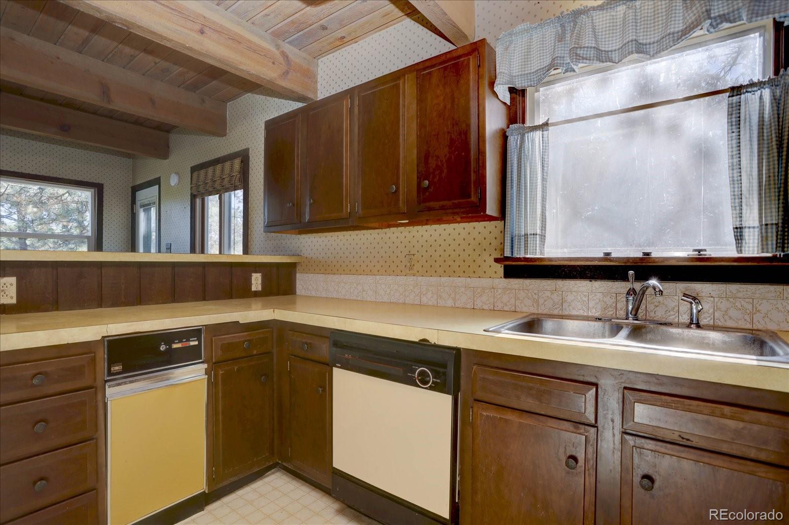 1999 Roland Drive Bailey, CO 80421 - Photo 19 of 33 a kitchen with a sink and cabinets