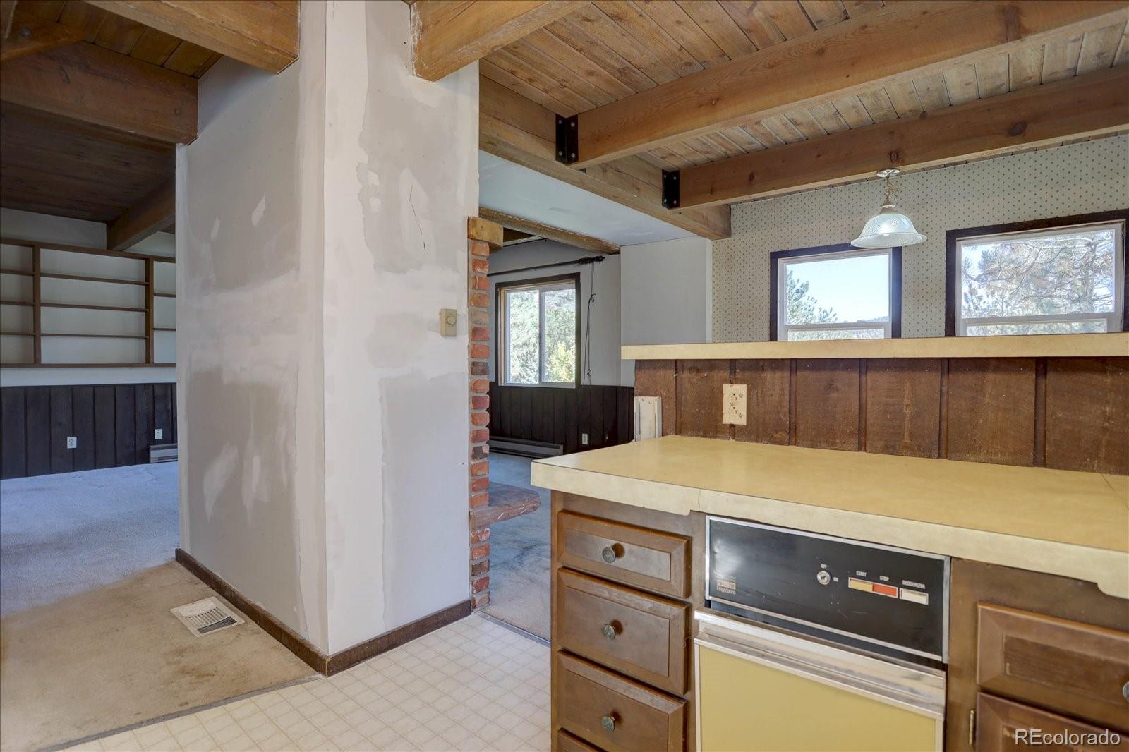 1999 Roland Drive Bailey, CO 80421 - Photo 20 of 33 a kitchen with a stove and a cabinet