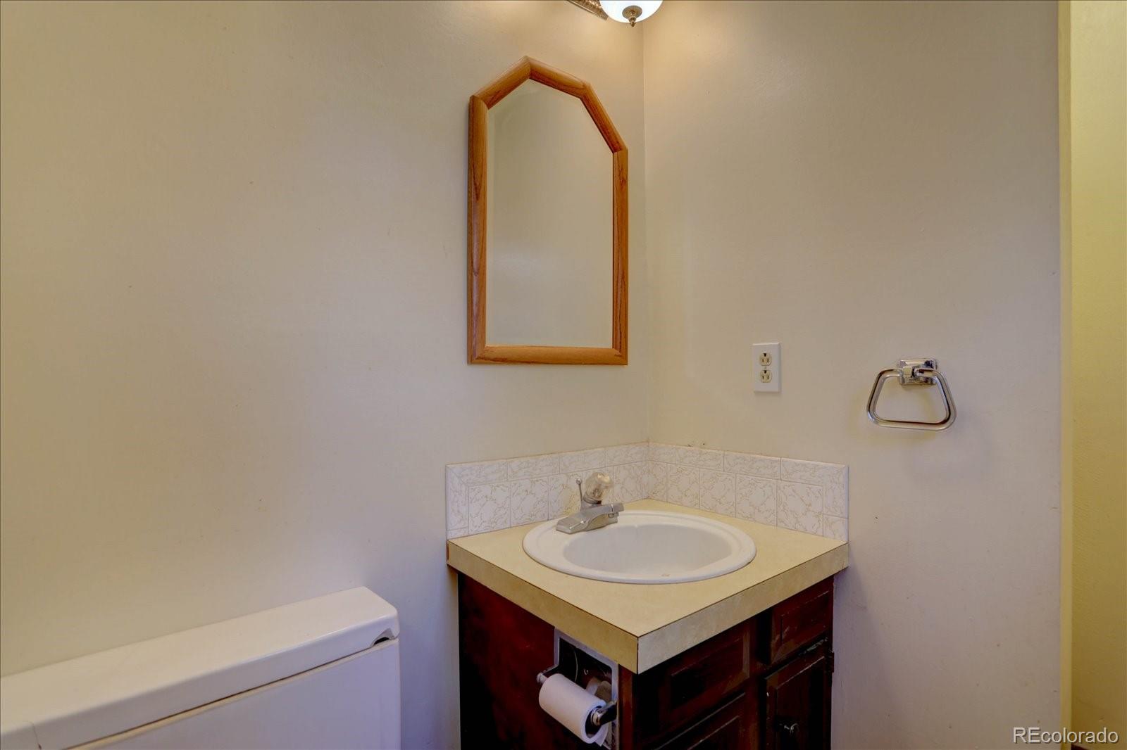 1999 Roland Drive Bailey, CO 80421 - Photo 21 of 33 a bathroom with a sink and a mirror
